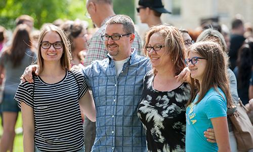 student with family members on family weekend 